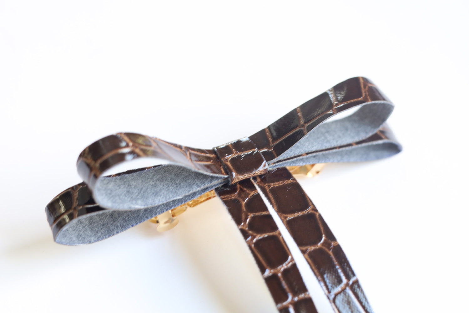 Vegan leather bow on a gold-plated clip