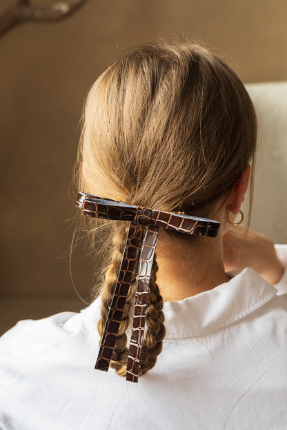 Vegan leather bow on a gold-plated clip
