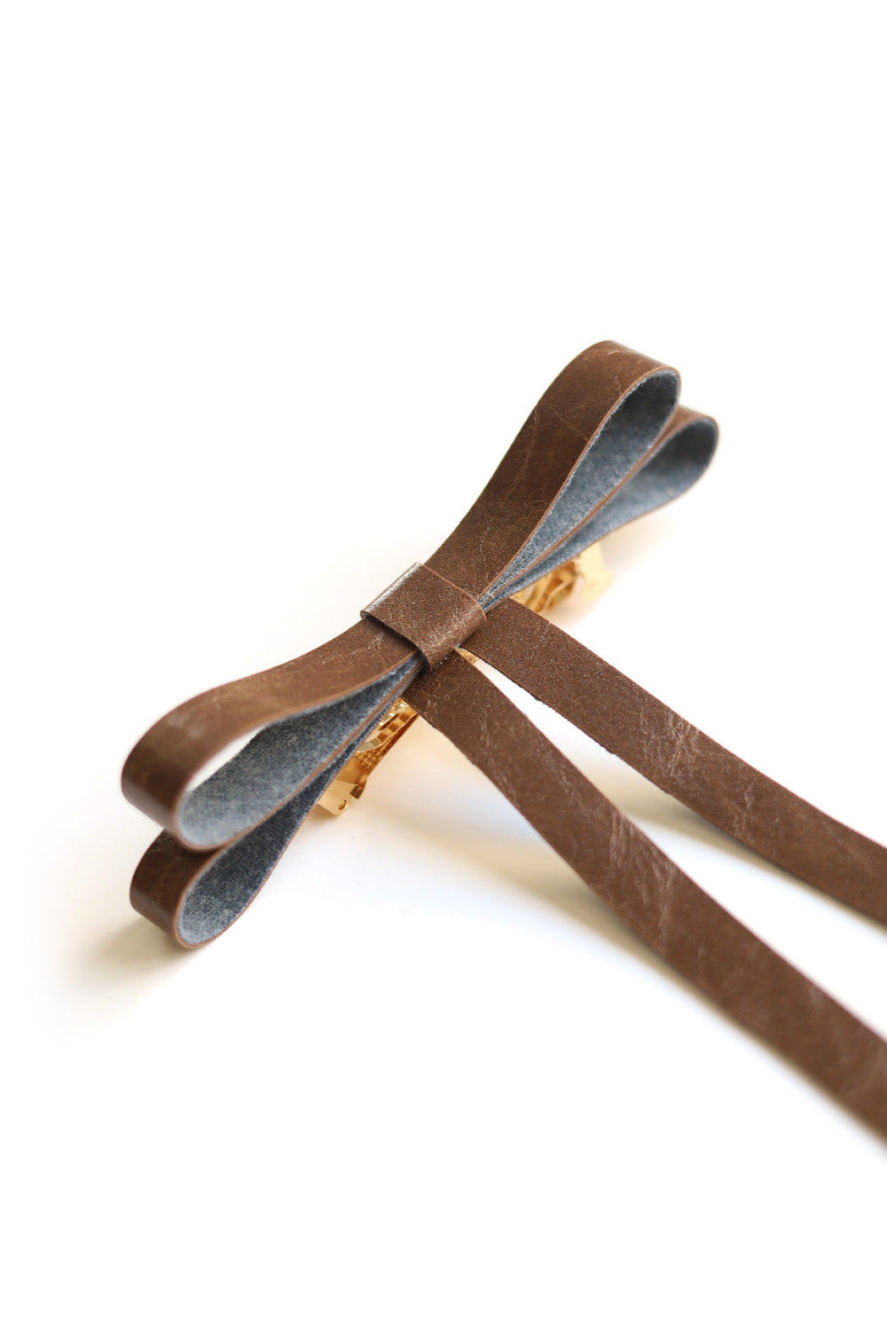 Vegan leather bow on a gold-plated clip